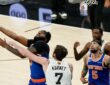 San Antonio Spurs center Luke Kornet reaches across New York Knicks center Mitchell Robinson as he goes up with the ball.